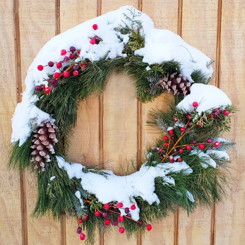 A wreath with snow on it - 2024 Gift Guide