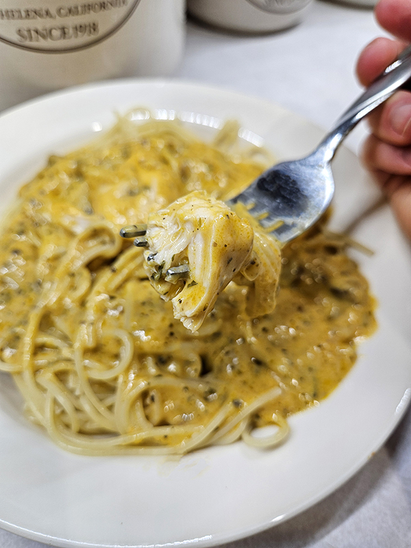 Angel chicken pasta on a fork ready for eating