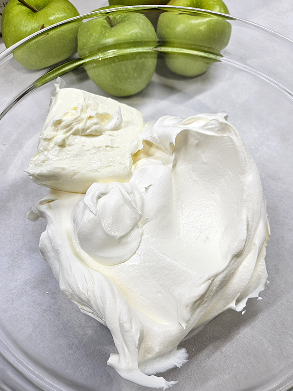 The cool whip and softened cream cheese before mixing - Apple Snicker Salad