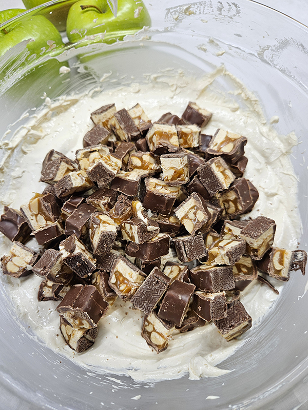 Adding chopped snickers