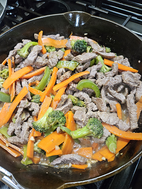 Simple Beef Stir Fry cooked and in a cast iron skillet