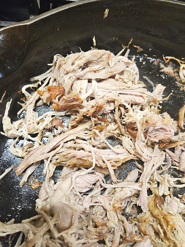 Searing shredded pork in a cast iron skillet - slow cooker carnitas