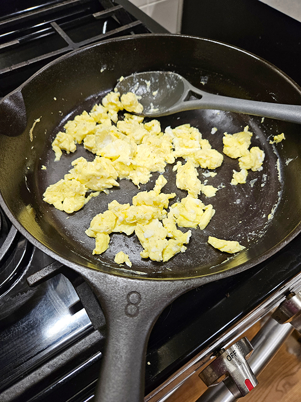 scrambled eggs cooking in a cast iron skillet - myths & facts