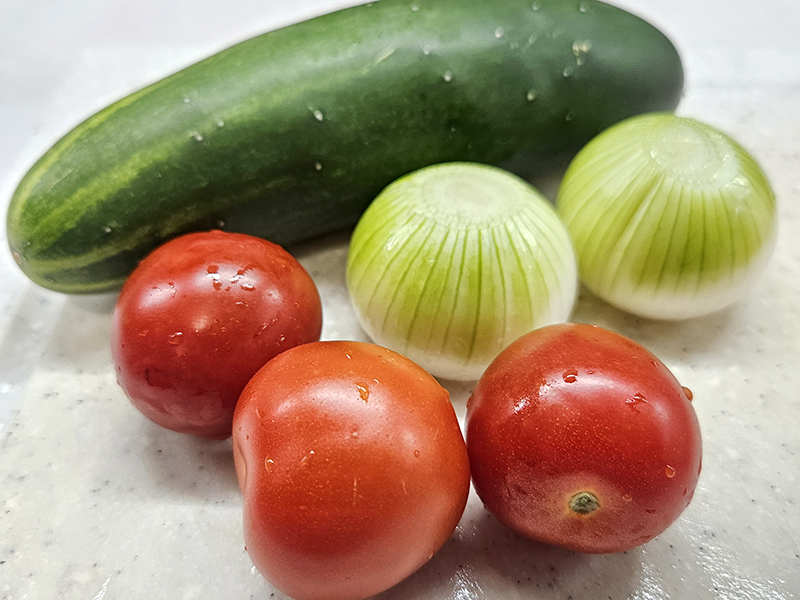 Cucumber, tomatoes, and onions for the salad