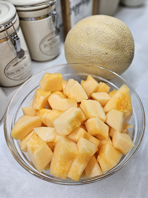 A whole muskmelon and one after cutting up