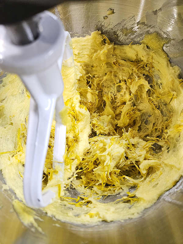 Adding the petals to the batter for the dandelion shortbread cookies