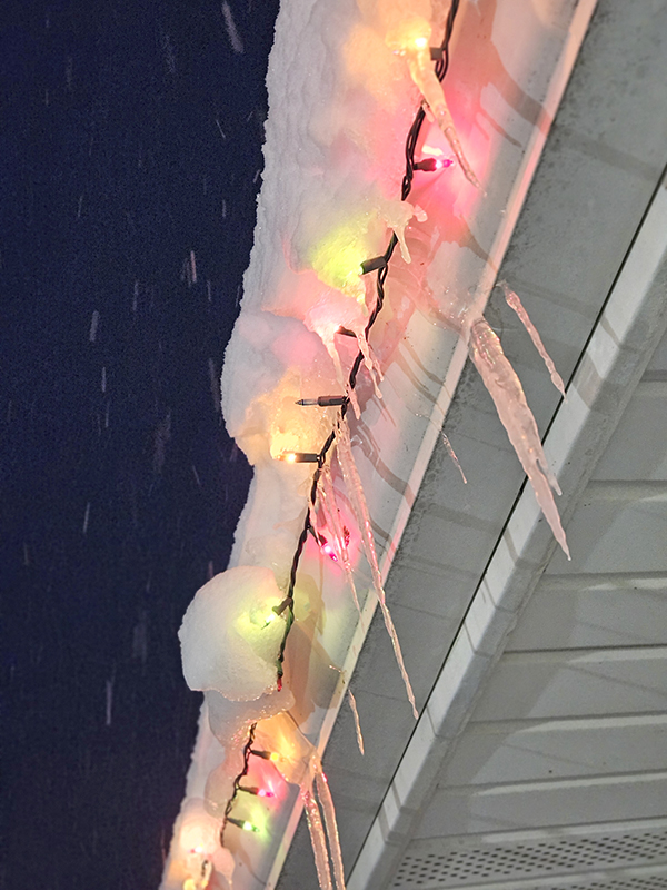 Ice and snow on top of Christmas lights