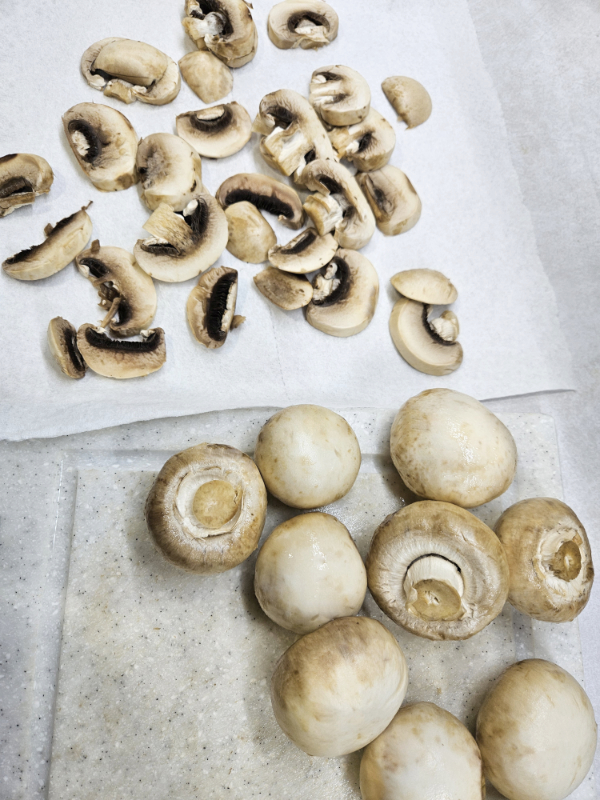 Button mushrooms on a cutting board - Dehydrate mushrooms