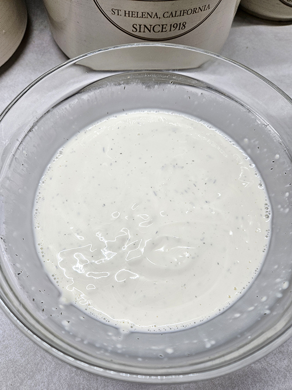 Dill pickle dressing in a bowl