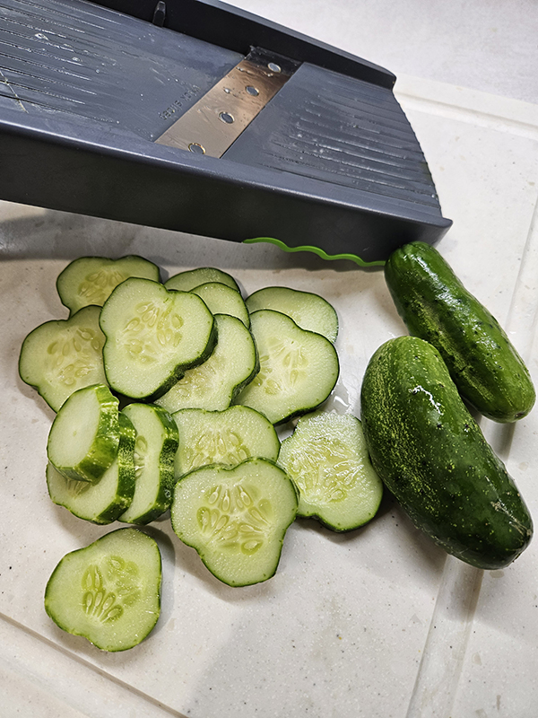 A mandible and a pile o sliced cucumbesr