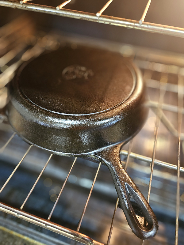 A pan in an oven ready for seasoning