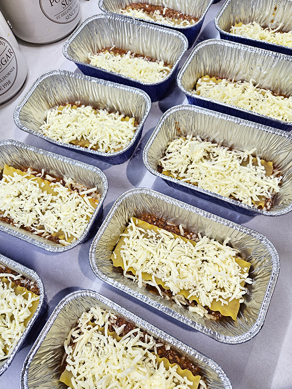Starting the layers on the personal sized freezer lasagnas