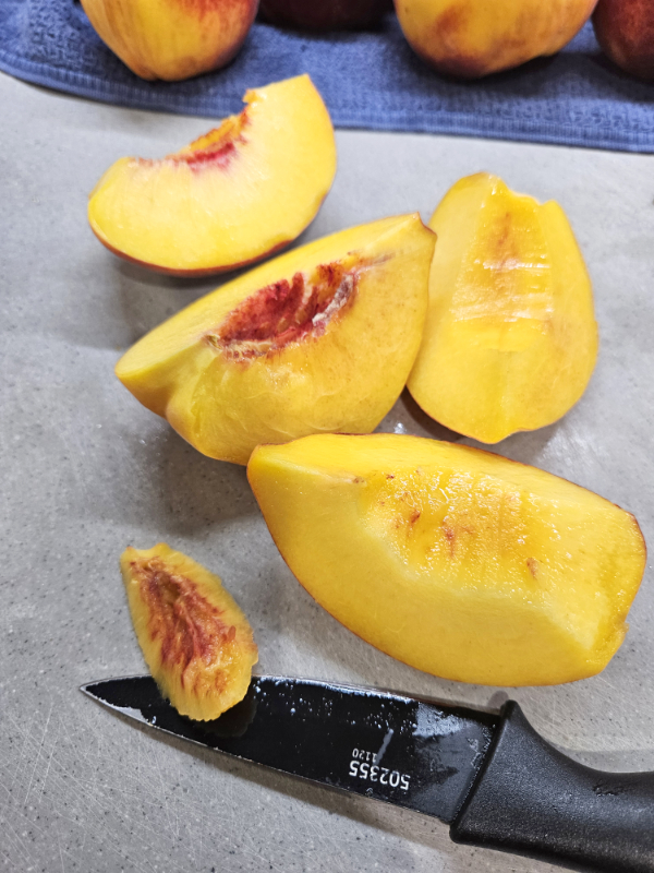 Slicing the peaches into quarters