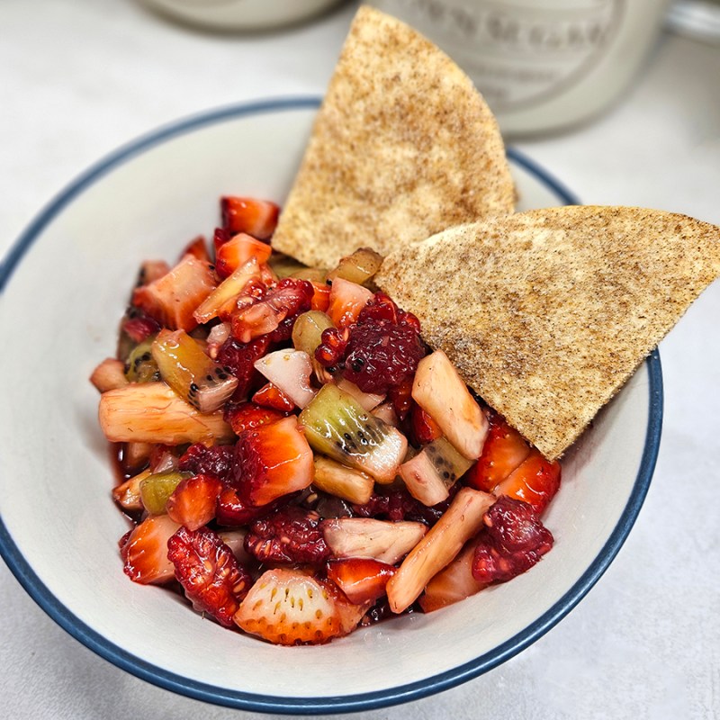 A bowl of fruit salsa and chips