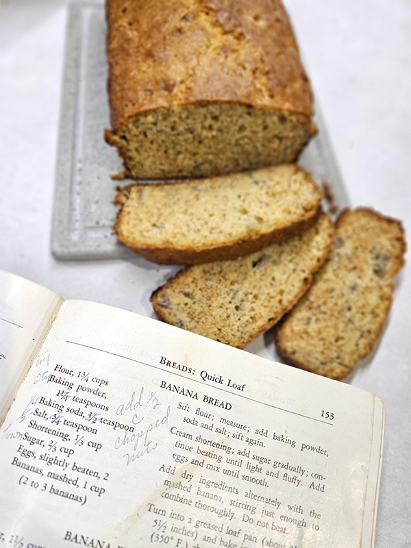 The handwritten notes on Grandma's Banana Bread recipe with the bread in the background