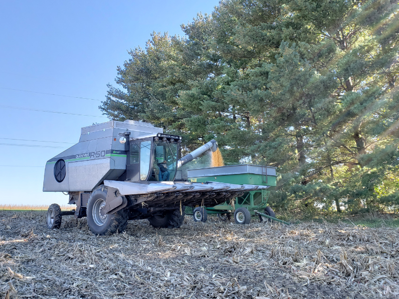 In order to properly introduce myself, you need to know where I came from. This image is my dad's combine unloading corn into a small green wagon.