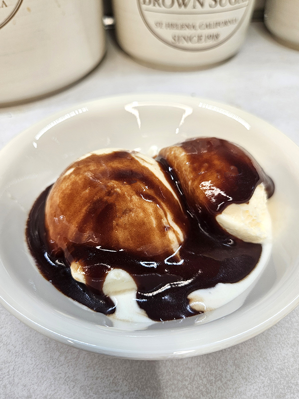 homemade hot fudge sauce over vanilla ice cream