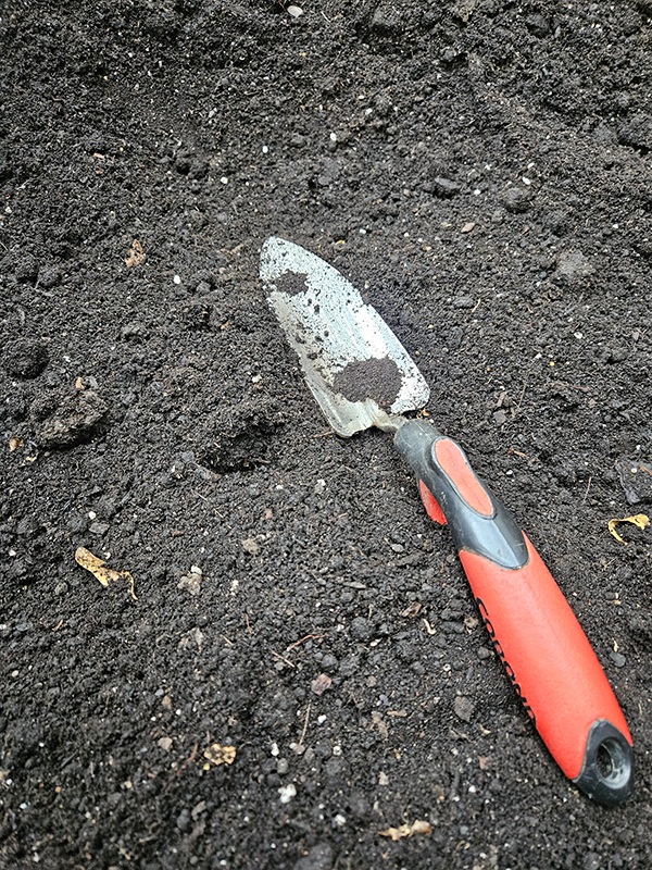Finished compost and a hand shovel