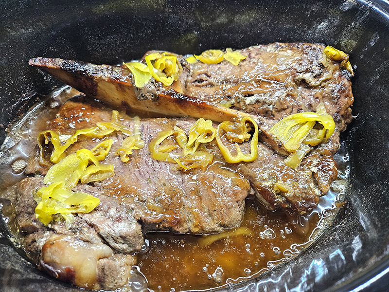 The cooked chuck roast in the slow cooker