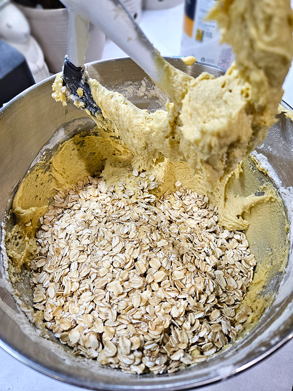 Adding the oats to the old fashion oatmeal raisin cookie batter