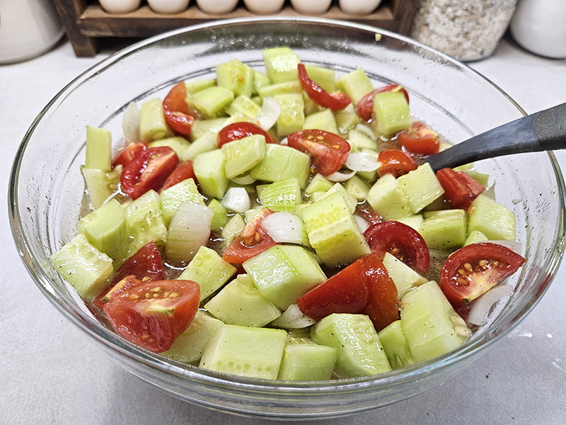 cucumber onion tomato salad in a bowl