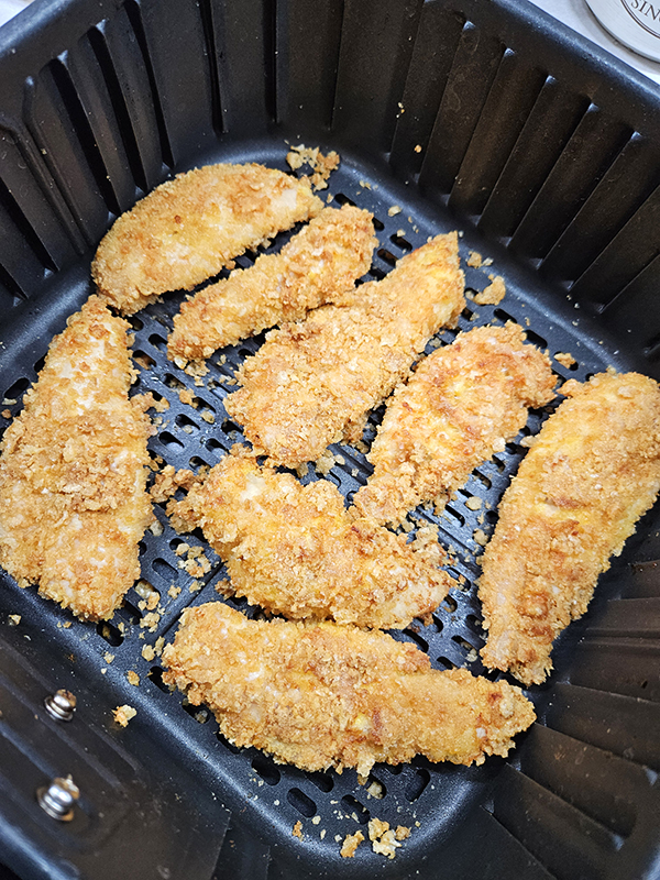 A finished basket of cooked pork panko crispy chicken tenders
