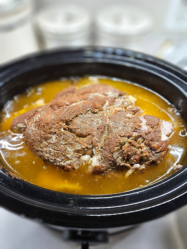 A cooked pork shoulder ready for shredding