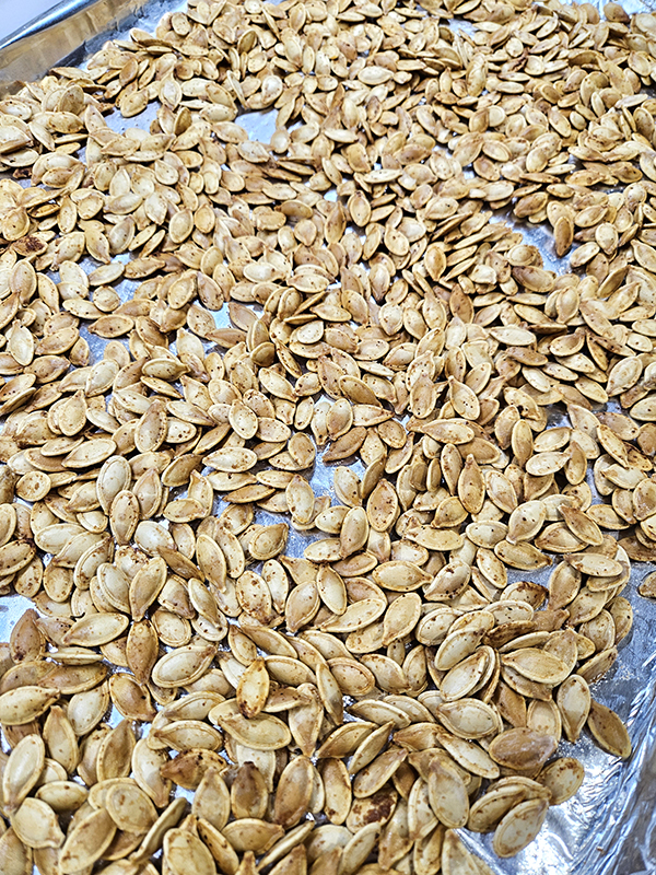 Cooked seeds on a foil-lined tray.