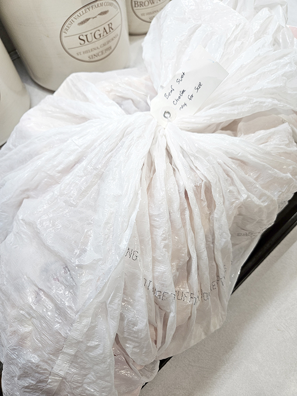 A bag of beef fat in a white bag