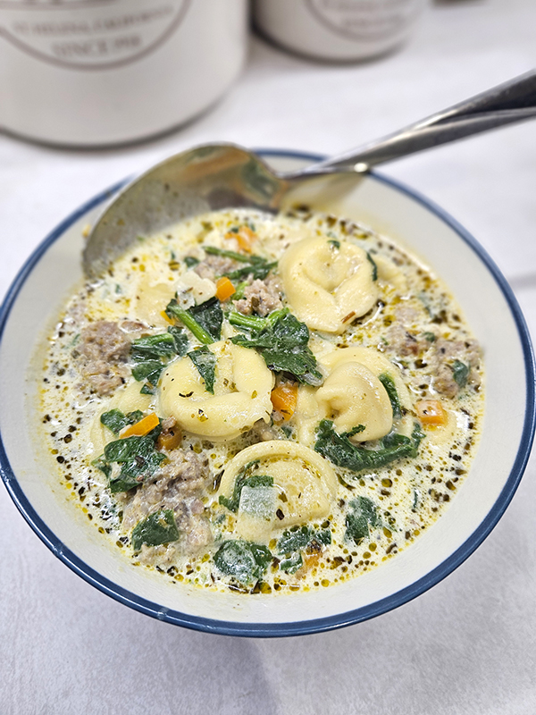 A bowl of sausage and cheese tortellini soup
