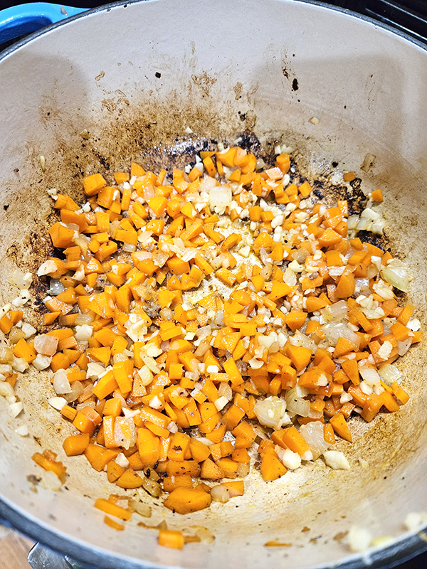Cooking the carrots, onions, and garlic