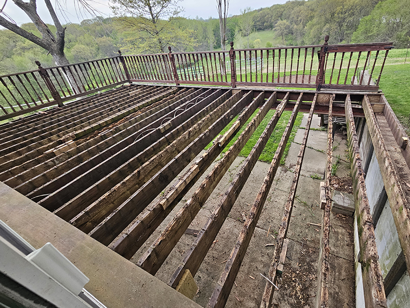 The old deck during demo with the top boards removed.