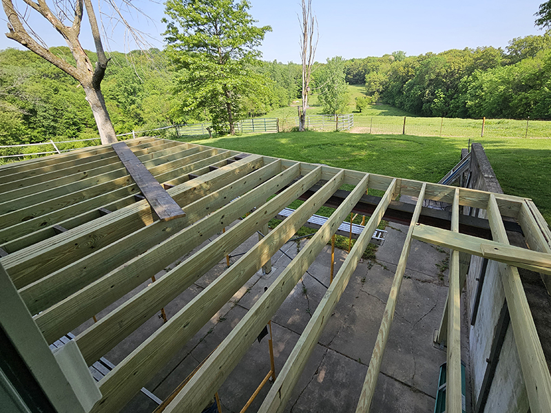 The framing of the new screened-in porch coming together