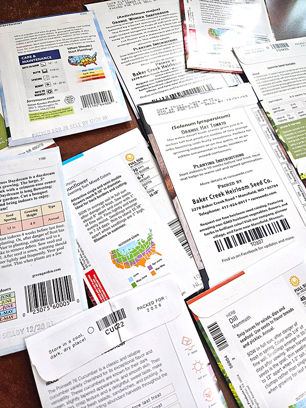 A pile of seed packets showing the back information