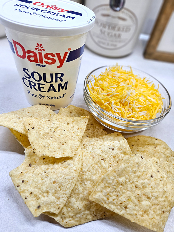 Chips, shredded cheese, and sour cream - shredded taco salsa chicken toppings