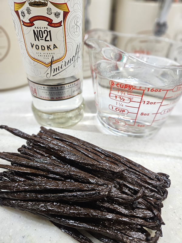 Ingredients for homemade vanilla extract - A bottle of vodka and vanilla beans