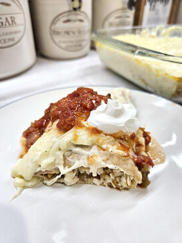 Easy White Chicken Enchiladas with salsa and cream cheese on top