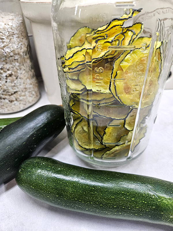A jar of crispy dehydrated zucchini chips